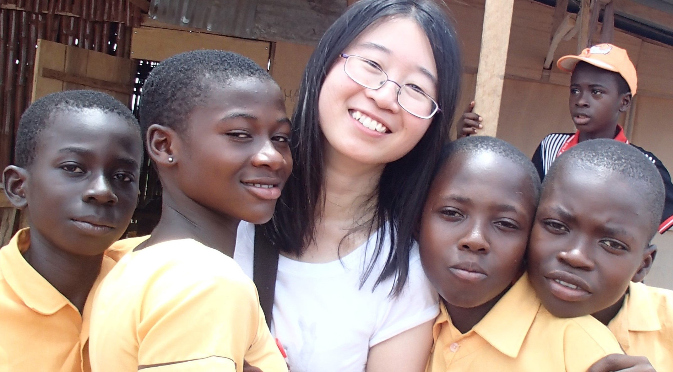 AfID volunteer Olivia with school children in Ghana